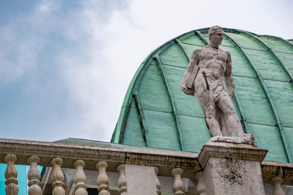 Statue at Basilica Palladiana with copper roof in Vicenza City in Italy